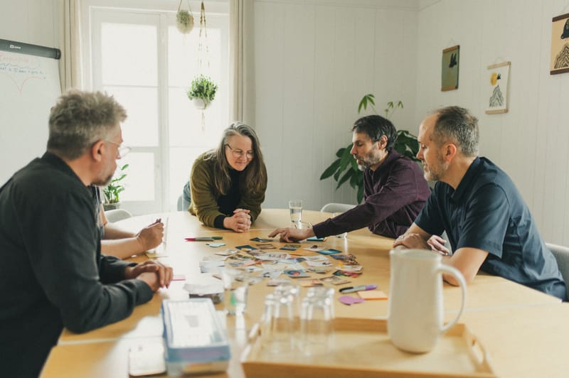Quatre personnes autour de la table de réunion — atelier ou rencontre
